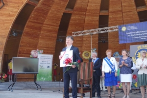 Występujący na scenie tańczą z pomponami, ze wstęgami. Na scenie dekoracja, pacynki Jacek i Agatka. Order Uśmiechu wręcza sekretarz Kapituły Orderu Uśmiechu i państwo Burcanowie.